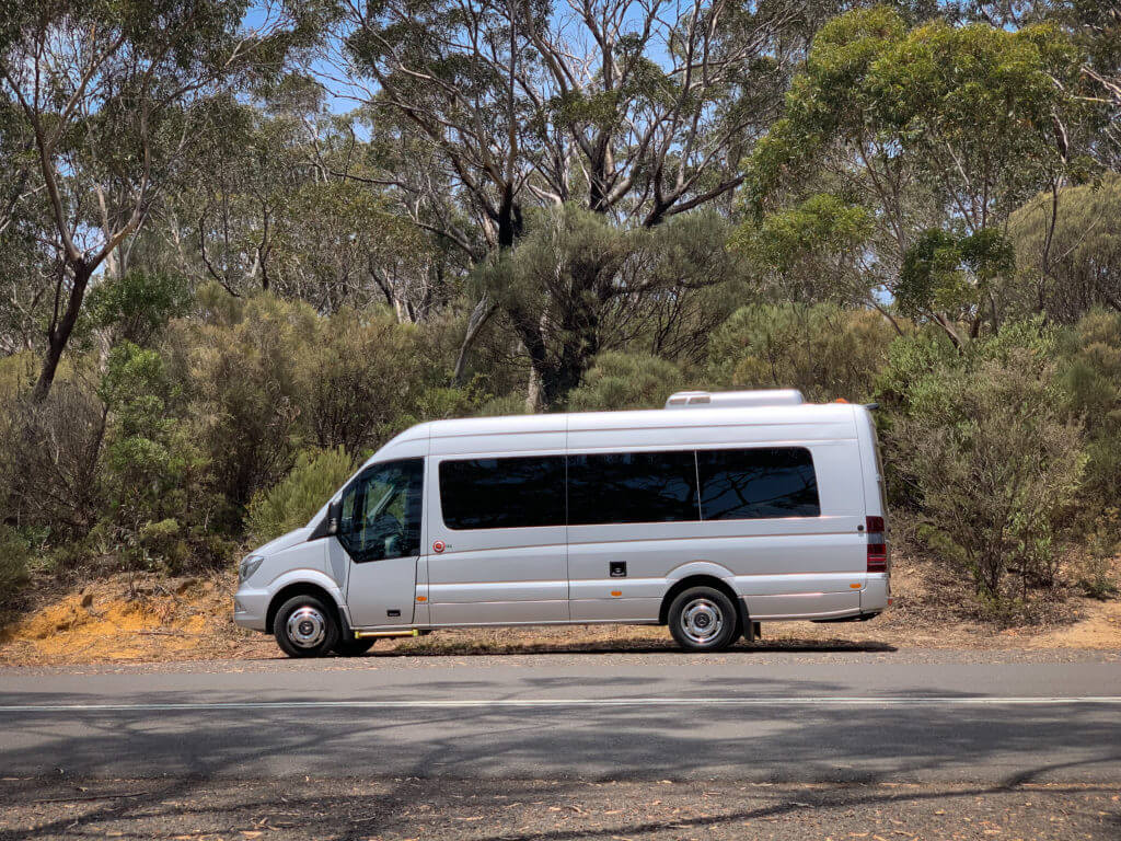 A comfortable Sprinter van on the road, offering scenic travel through the beautiful Blue Mountains.